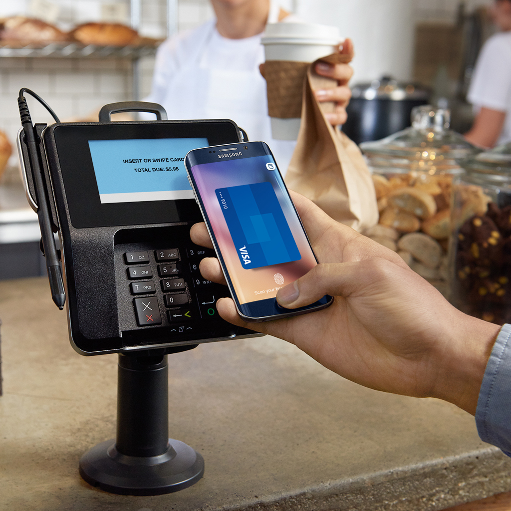 An individual is seen utilizing Samsung Pay to make a payment for food, replacing the need for a paywave card. 